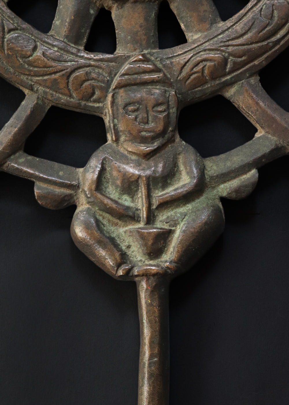 Antique cast bronze dharmachakra with a central lotus rosette within the spoked wheel