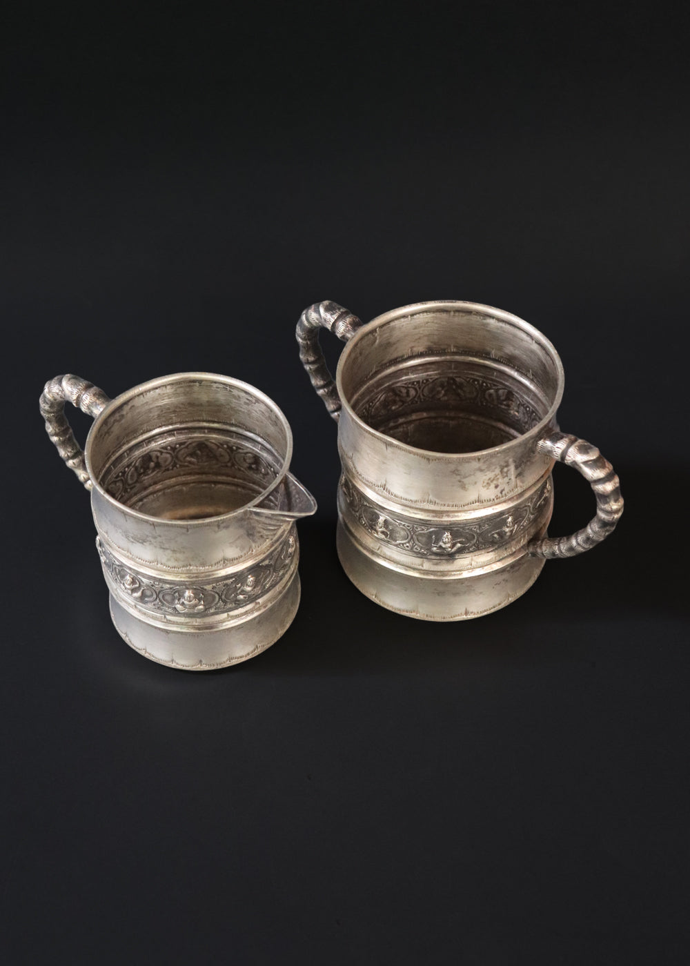 Antique silver plated “Swami” style milk pot and sugar bowl in the style of P.Orr and sons, the important silversmith firm in Colonial South India. They depict seated divine figures.