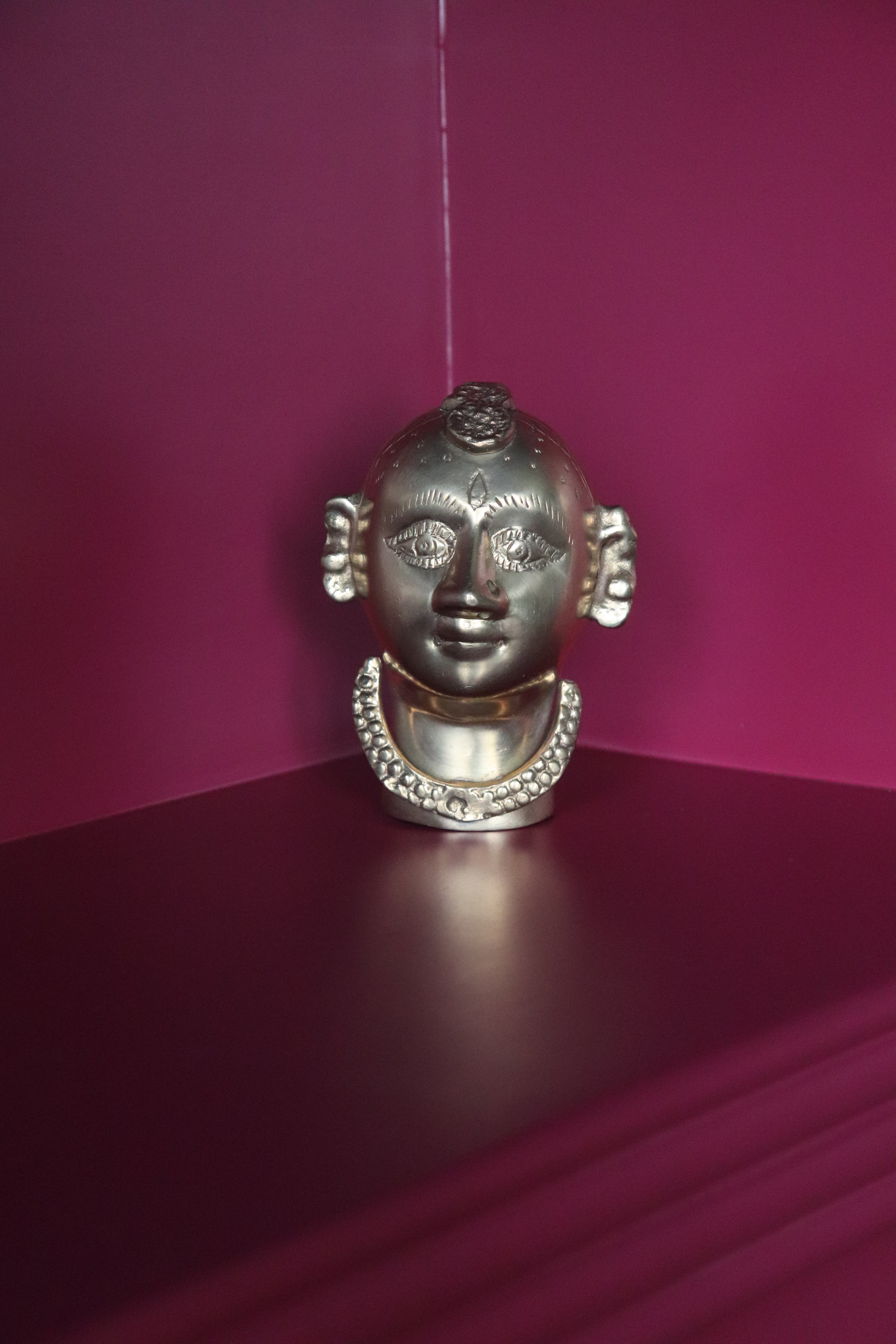 Vintage Brass Gauri head, the divine embodiment of Shakti, the Mother Goddess, the benevolent form of Parvati. She is highly bejewelled with a neckpiece, head and ear ornaments. The nose has a provision to adorn it with a nose ring. The piece has ben recently polished, and is in great condition From the mid 1900s India.