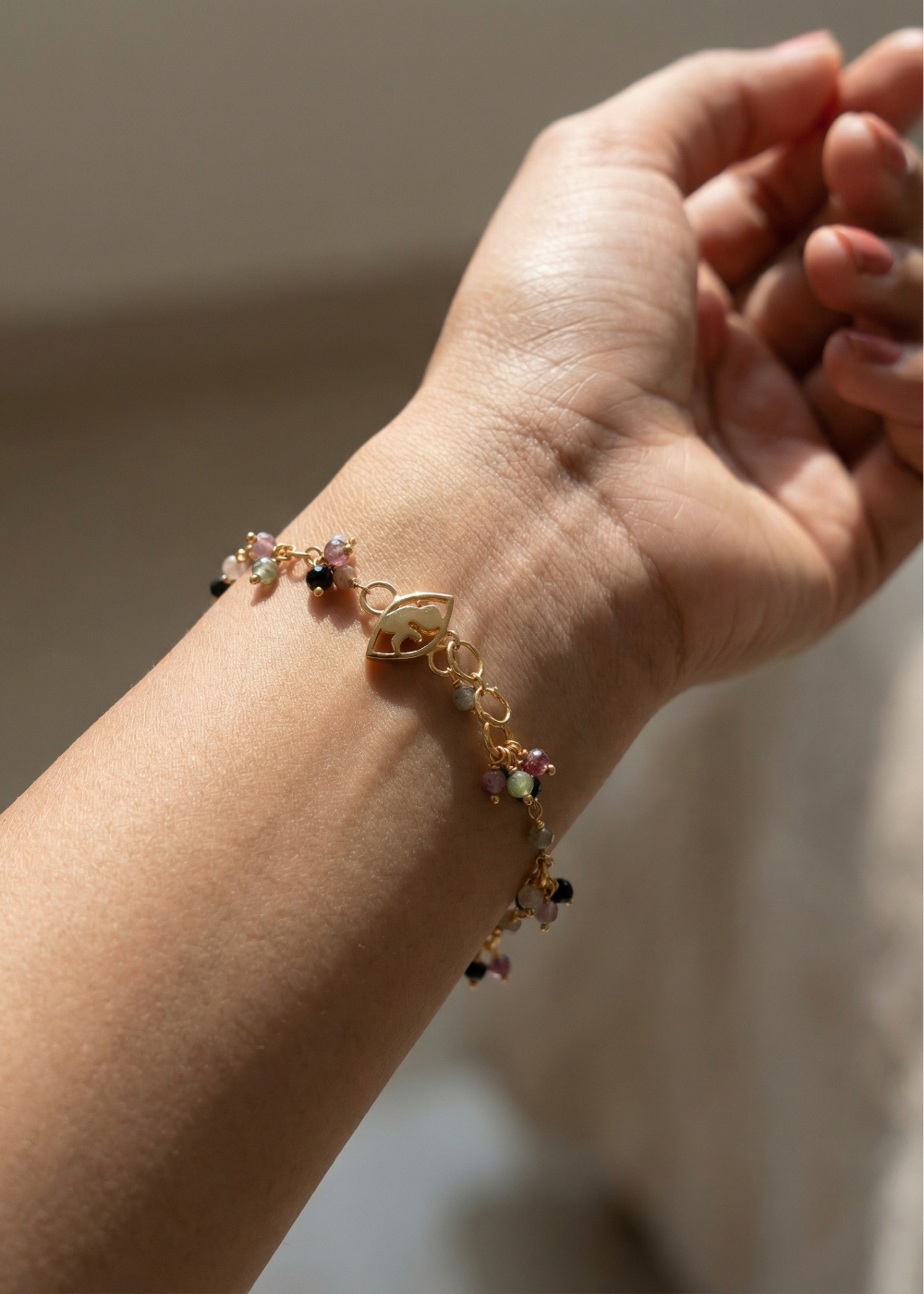 Multi-coloured Tourmaline bracelet with 'foetus' motif lock.