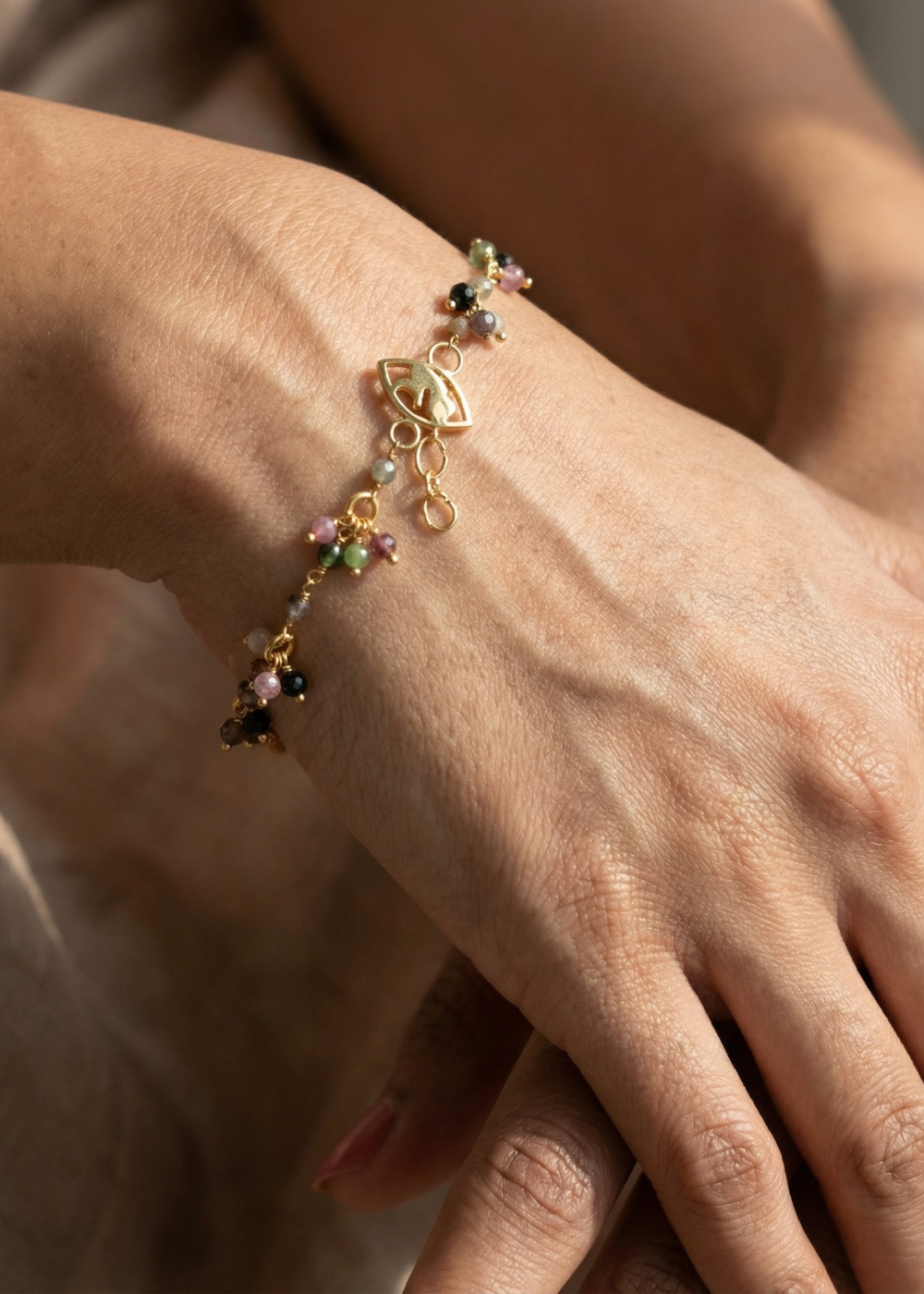 Multi-coloured Tourmaline bracelet with 'foetus' motif lock.