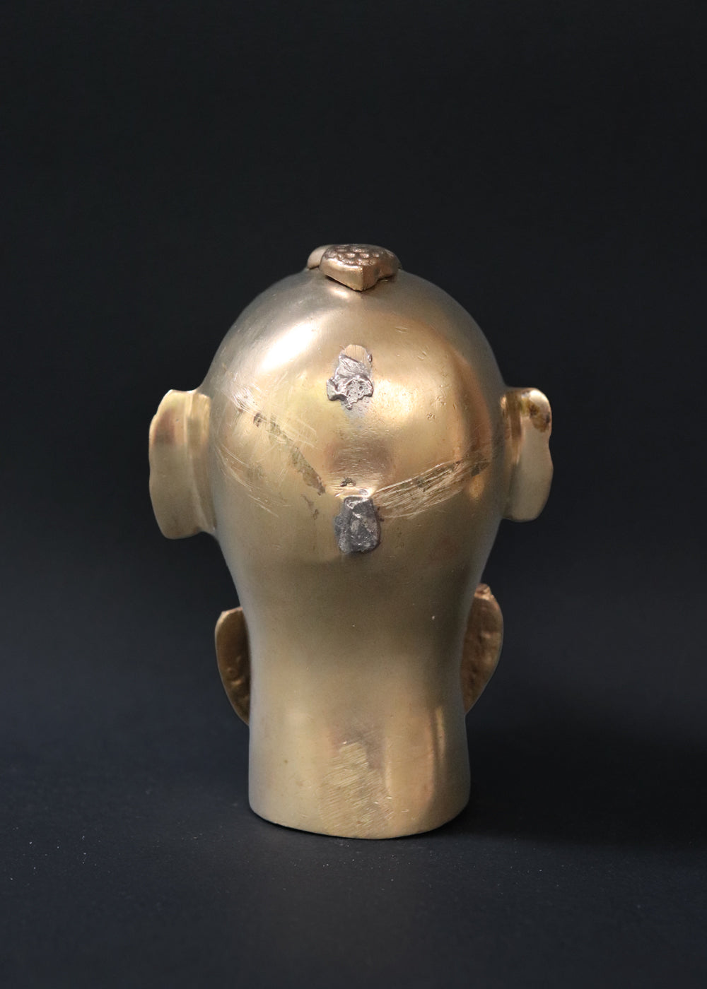 Vintage Brass Gauri head, the divine embodiment of Shakti, the Mother Goddess, the benevolent form of Parvati. She is highly bejewelled with a neckpiece, head and ear ornaments. The nose has a provision to adorn it with a nose ring. The piece has ben recently polished, and is in great condition From the mid 1900s India.