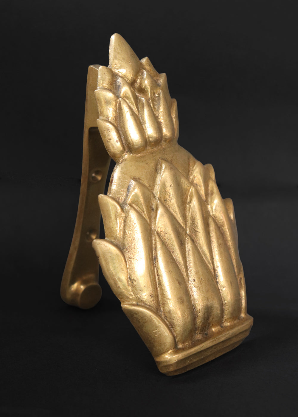 Vintage Newport brass door knocker. It is solid and heavy and was made by Virginia Metal crafters for their very popular Newport line. The pineapple knocker was especially beloved because the fruit is an enduring symbol of hospitality, wealth, and a safe return from sea voyages, a tradition with deep roots in Newport's maritime history. Made in the US, 1960s.