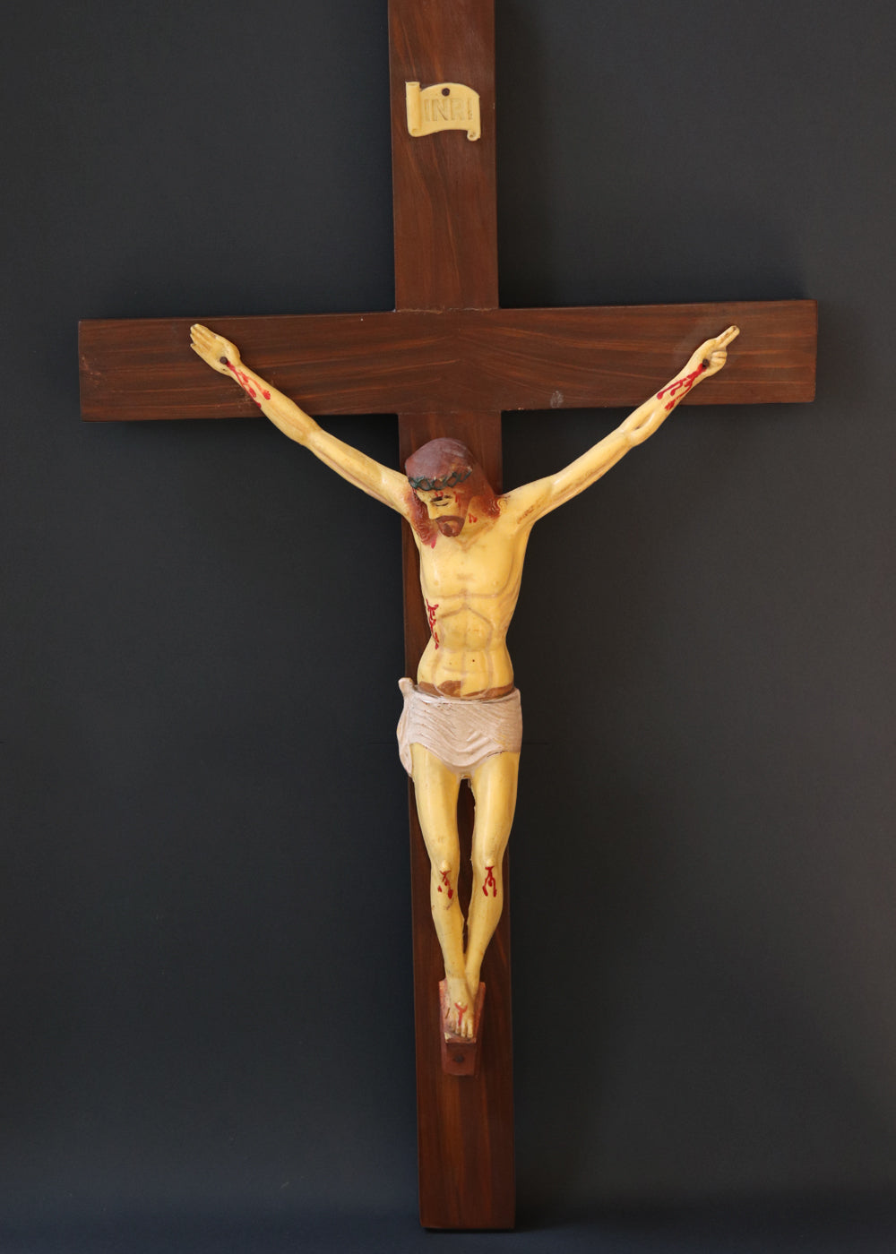 Vintage crucifix with Jesus probably made out of celluloid which is a form of early plastics. The moulded celluloid has been painted with details and the cross carries the traditional INRI plaque at the top. These lighter pieces were made to be a part of home altars, and should be from between the 1950s-1920s, India.
