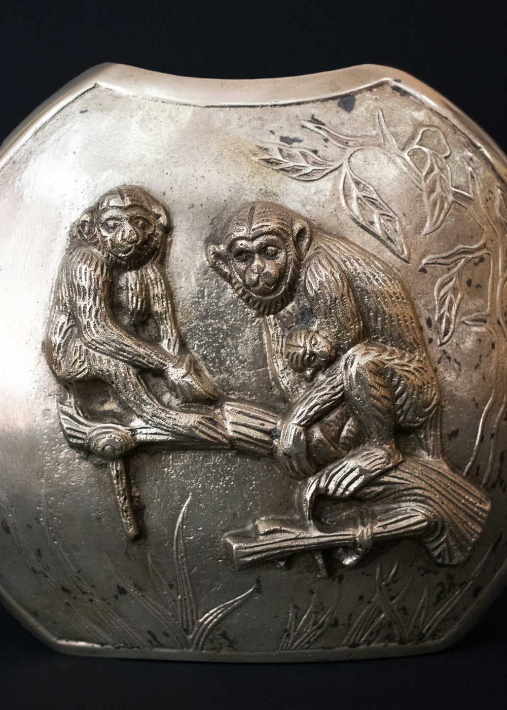 Vintage Meiji style vase with a family of Japanese macaques in high relief, surrounded by foliage. Macaques were considered sacred mediator between gods and humans, and represent good fortune, protection against evil, and wisdom. The same design is on both sides of the vase, the naturalistically rendered mother macaques caries a baby while another young macaques stands near them. The vase is cast in bronze or brass, and should bee from thee early 1900s Japan.