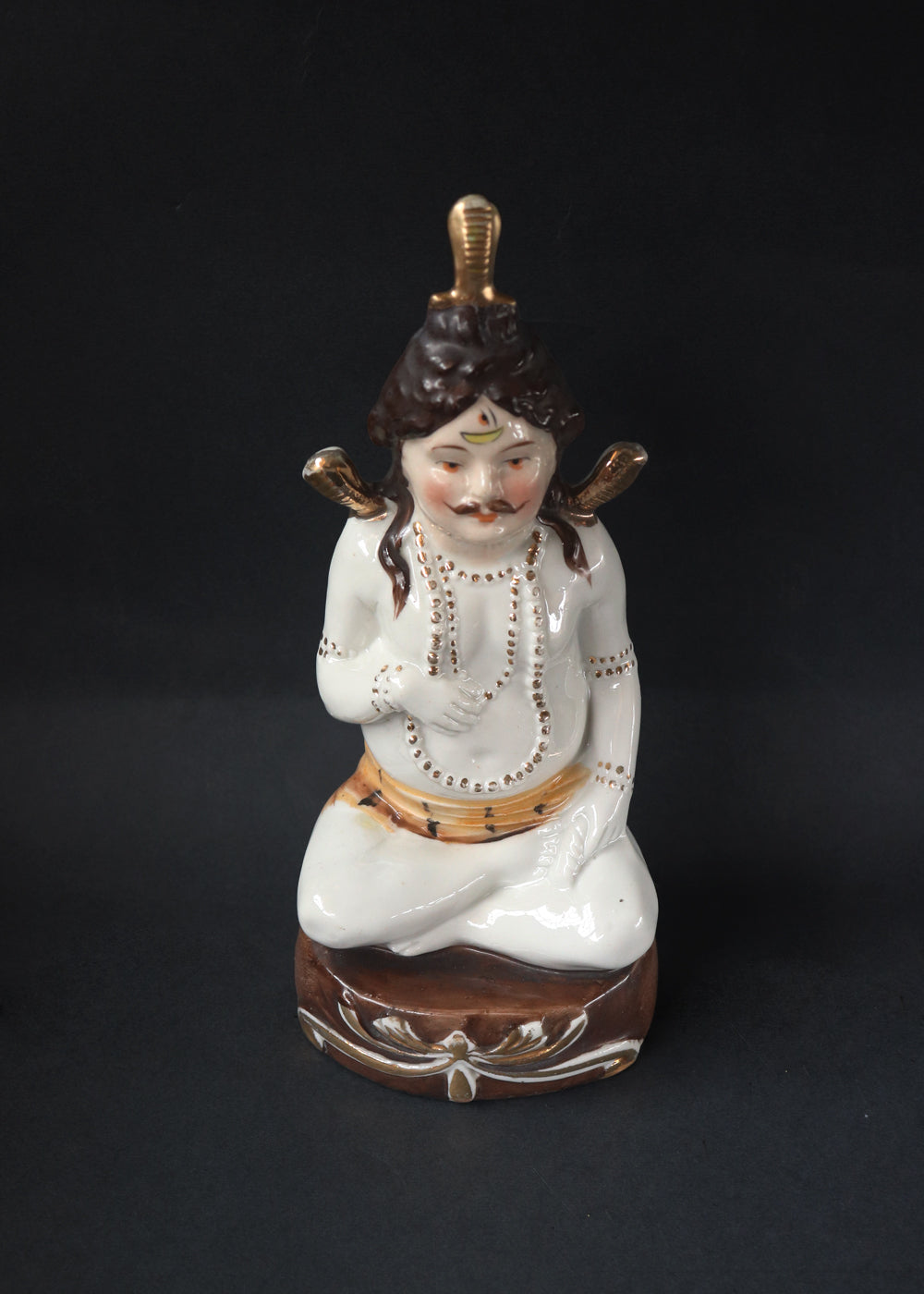 German made porcelain slip cast figure of Lord Shiva made for colonial India in the early 1900s. These figures were inspired by paintings by Raja Ravi Varma.