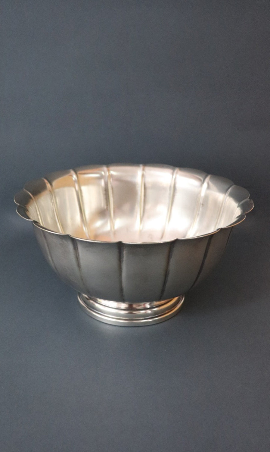 Vintage silver plated Rose Bowl with a classic lobed body and a scalloped undulating rim. The panels sweep upward to form an elegant petaled shape and it is raised on a stepped round pedestal base. It has the markings Sheffield England and a brand name that’s hard to read on the base. It would make a gorgeous centrepiece on dining or console table. Should be from the mid 1900s, England.