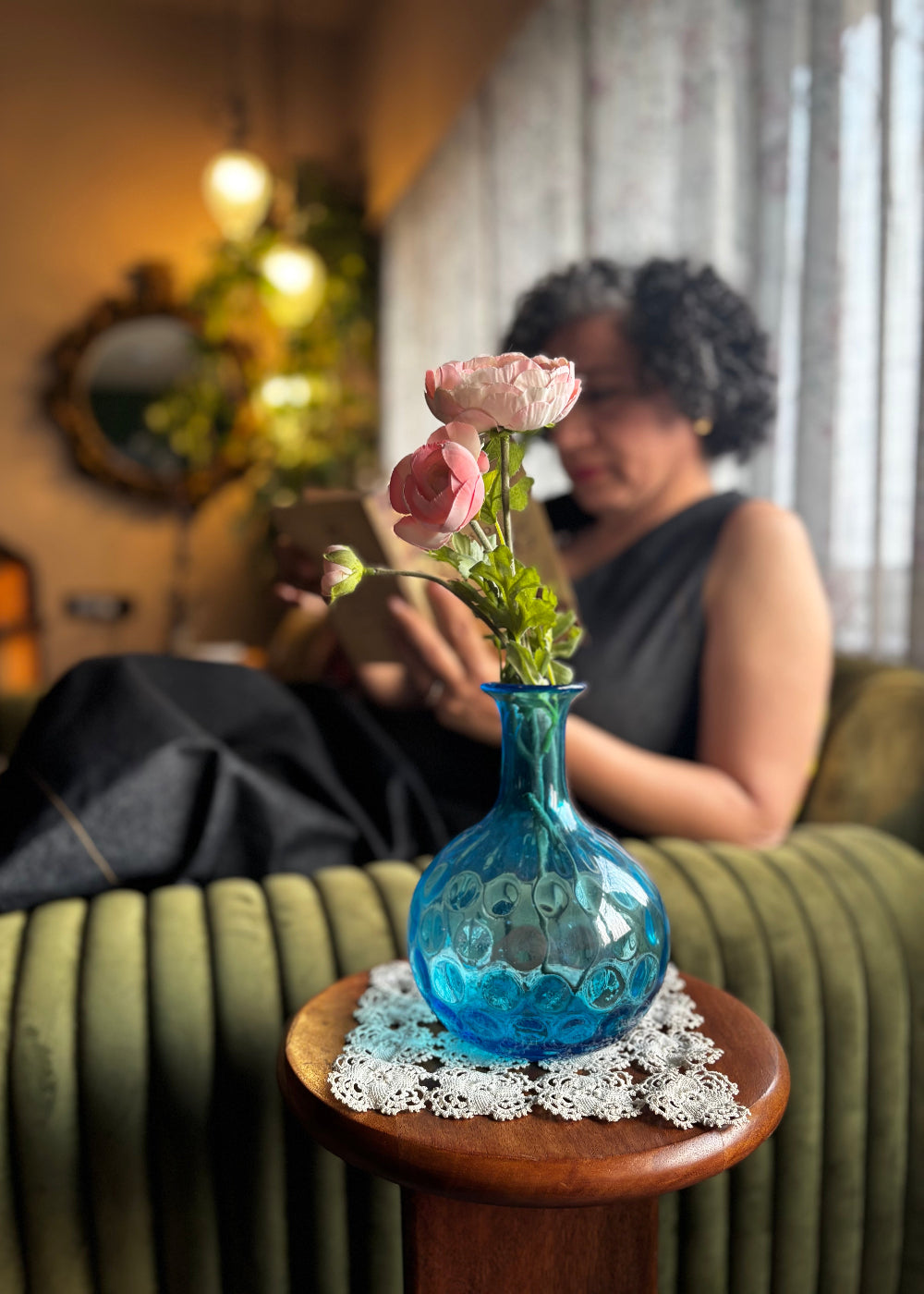 Vintage turquoise blue dimpled glass vase with a onion shaped body. It has a narrow elongated neck which widens out slightly to a rounded rim. The coin, dot or thumbprint pattern on its body is typical of the early to mid 1900s. Can also be used as a decanter.