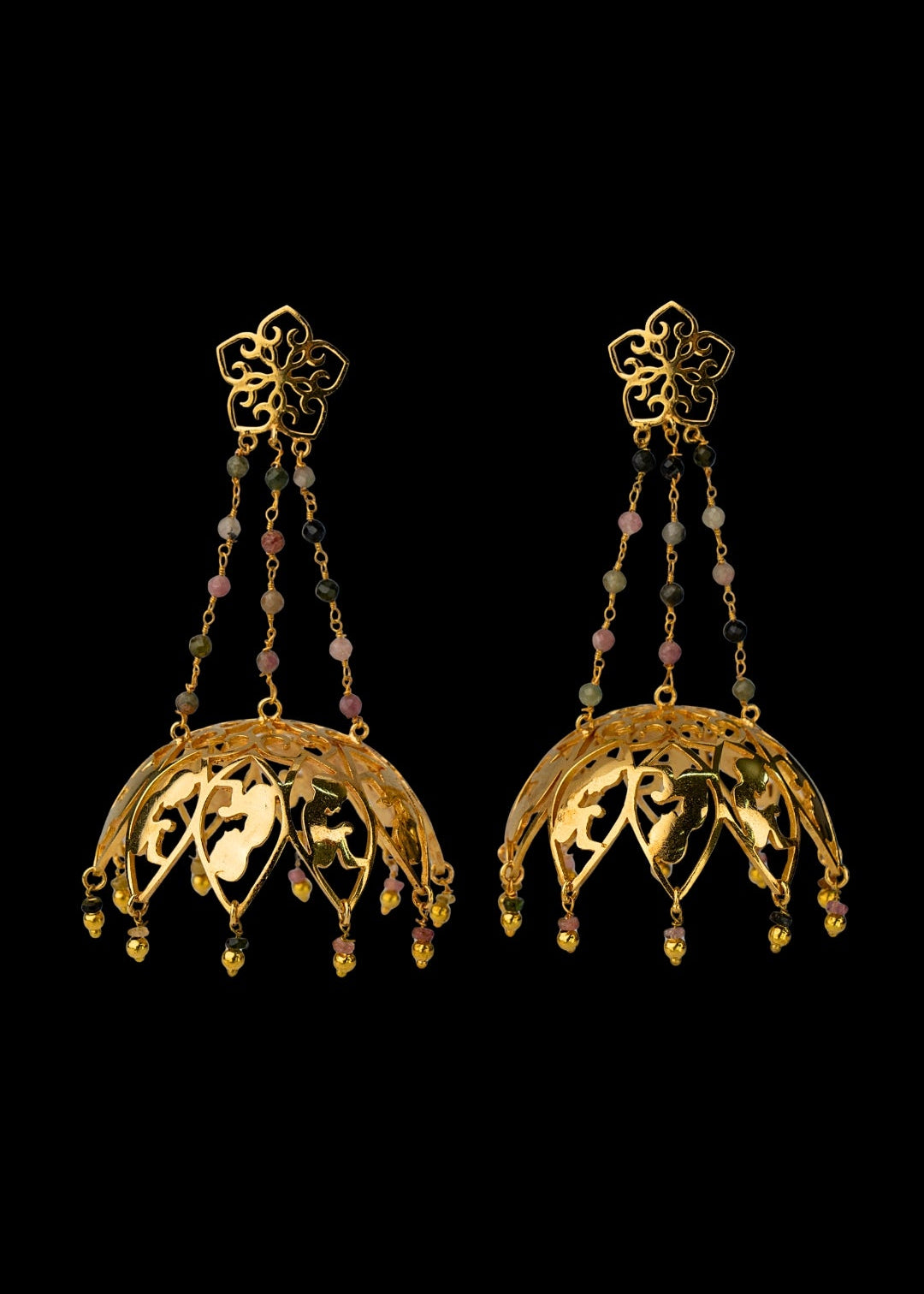 Pair of gold earrings with intricate designs on a black background
