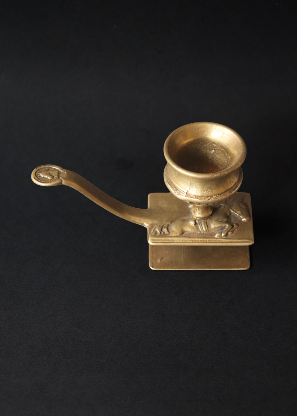 Vintage brass chamberstick with an integrated matchbox case