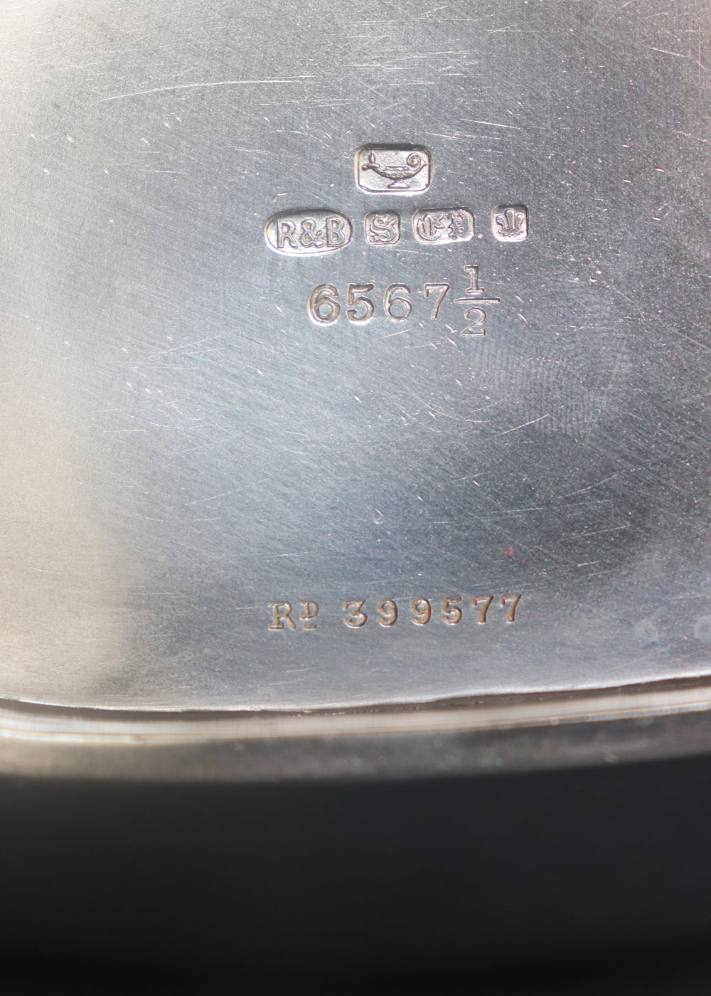 Close-up of the polished silver-toned interior base of a vintage R.M.