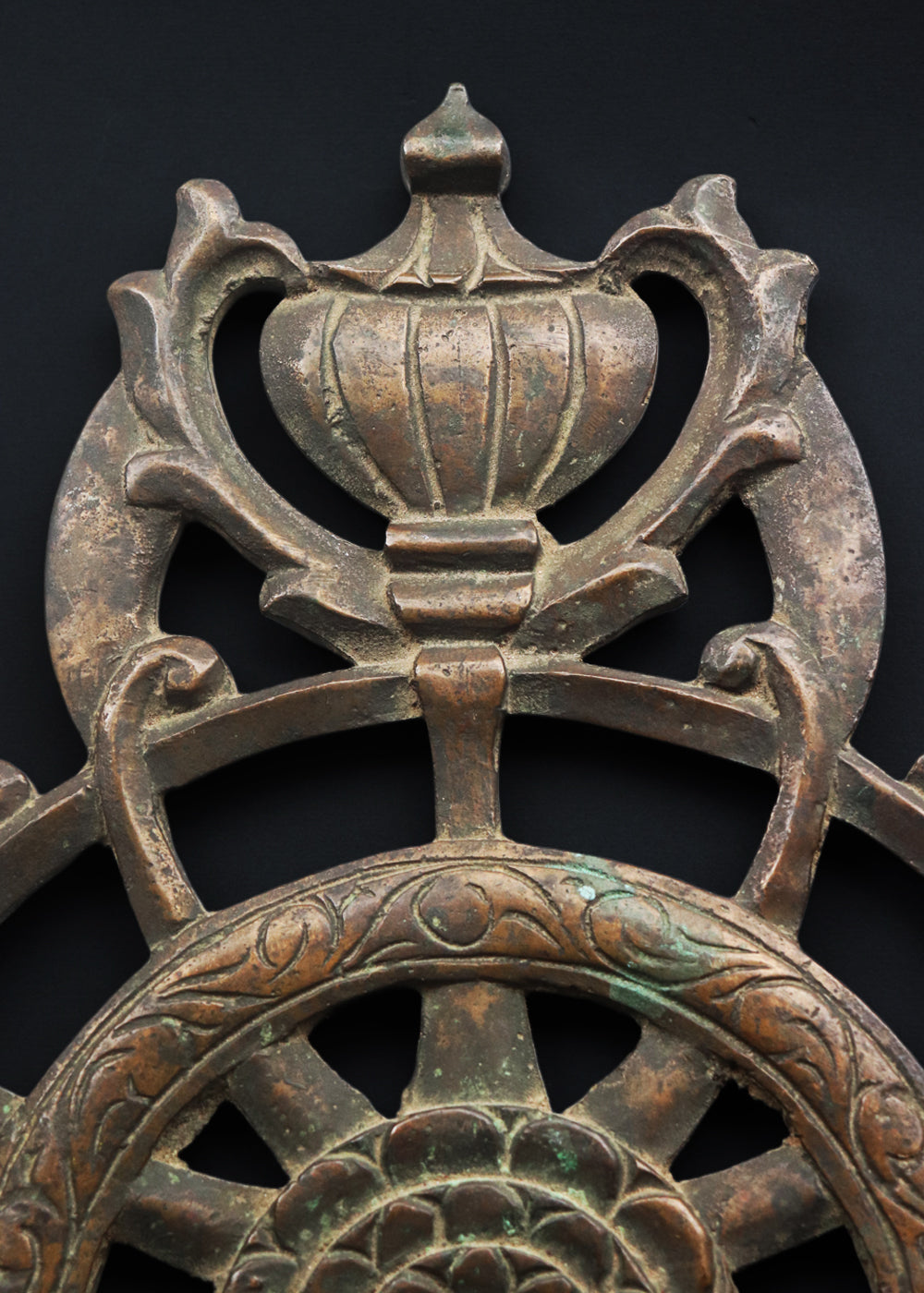 Antique cast bronze dharmachakra with a central lotus rosette within the spoked wheel
