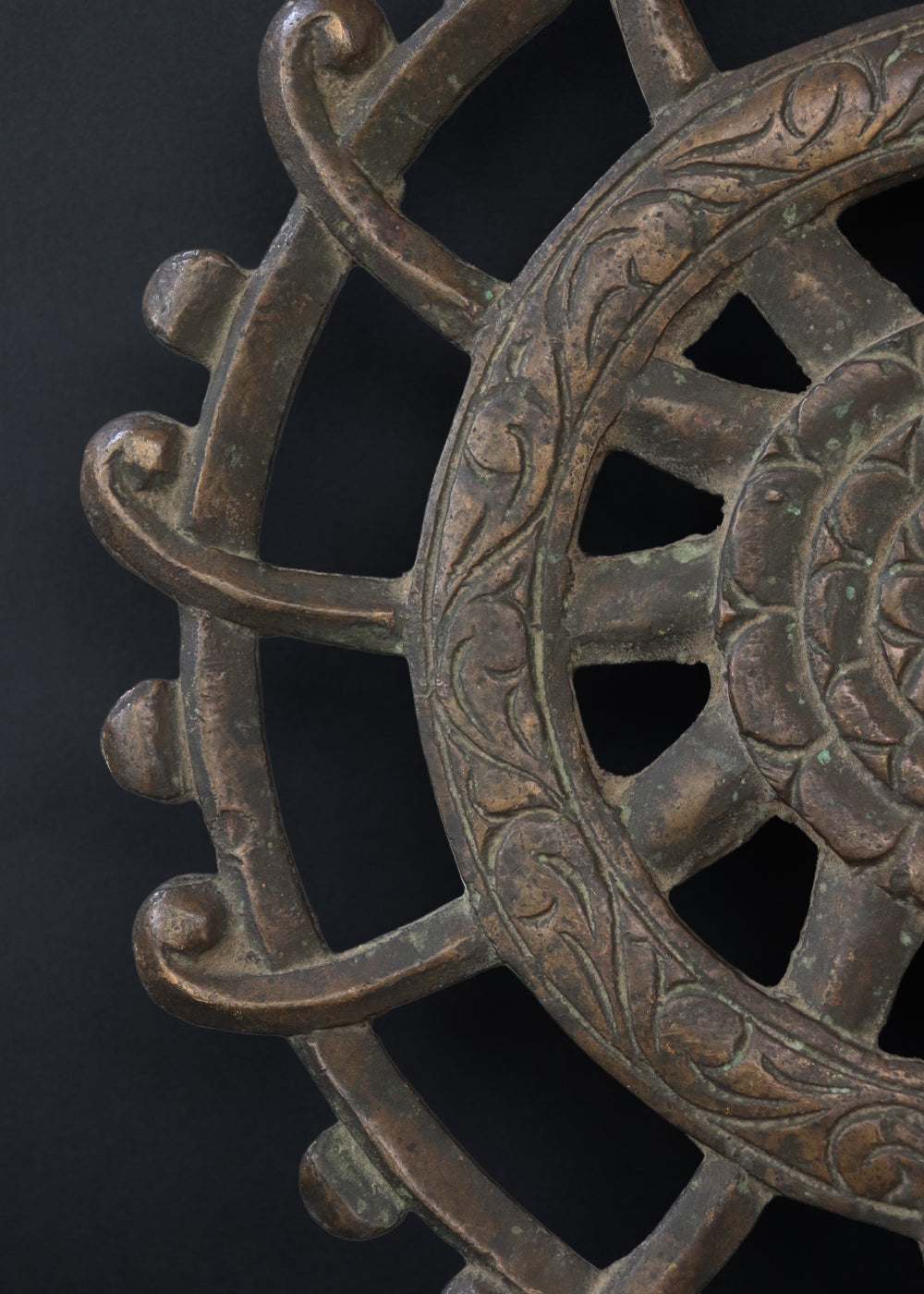 Antique cast bronze dharmachakra with a central lotus rosette within the spoked wheel