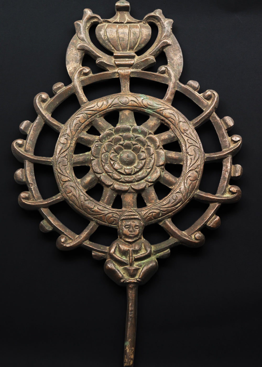 Antique cast bronze dharmachakra with a central lotus rosette within the spoked wheel