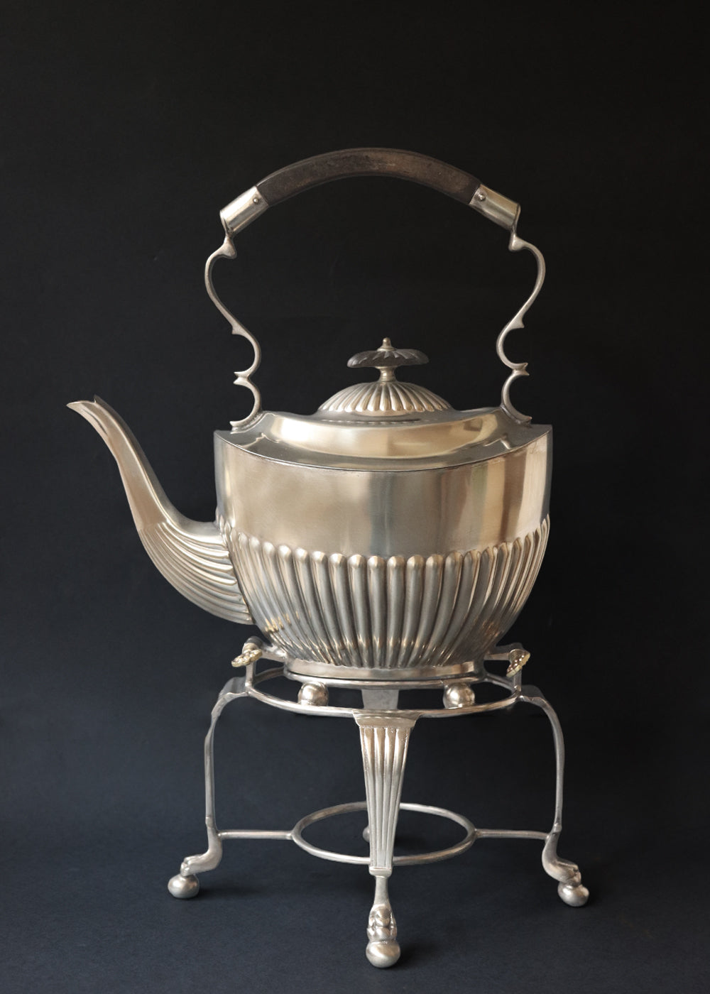 Antique Edwardian silver plated spirit kettle on a matching stand.