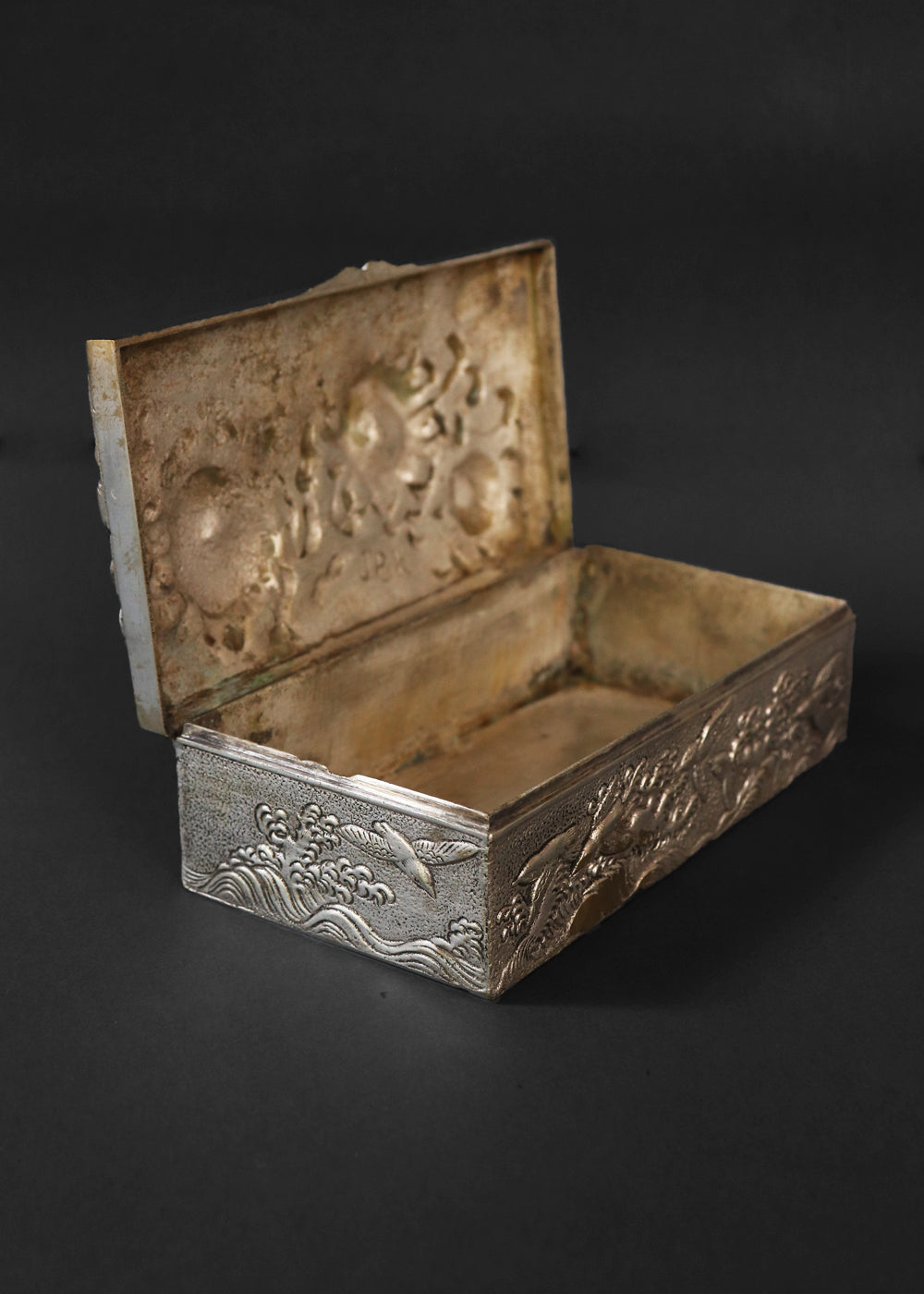 Meiji period Japanese box with very beautifully detailed chrysanthemums “kiku” in high relief and almost life-like petals. In Japan, the chrysanthemum is very cherished as a symbol of the imperial house, and the term “chrysanthemum throne” refers both to the actual throne as well as the emperor himself. Every year the 'Festival of Happiness' is celebrated in honour of the chrysanthemum. The side panels of the box depict birds in stormy seas with waves in the style of The Great Wave by Hokusai, all in relief