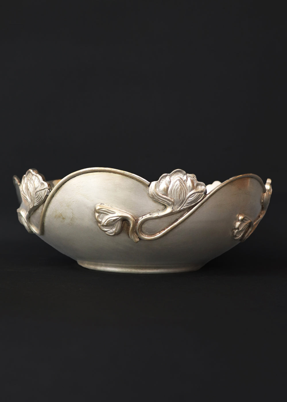 Beautiful silver-plated Art Nouveau bowl decorated with water lilies. The curvaceous floral and vine are cast and applied on the scalloped rim and sides of the bow and are classic art nouveau. This is a perfect fruit bowl or center piece. Made in France, early 1900s.