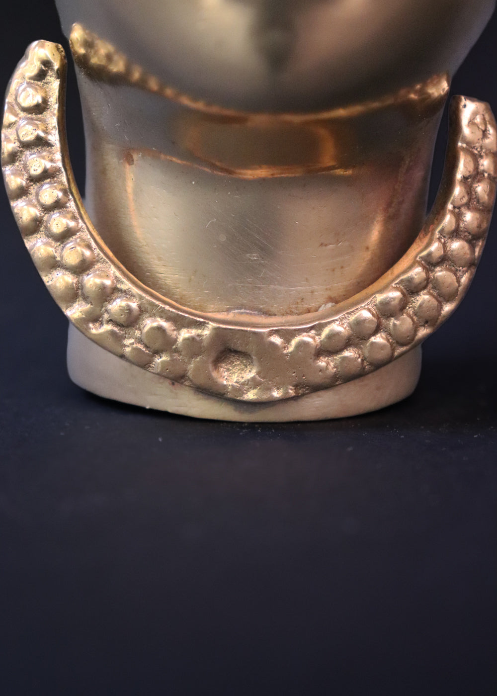 Vintage Brass Gauri head, the divine embodiment of Shakti, the Mother Goddess, the benevolent form of Parvati. She is highly bejewelled with a neckpiece, head and ear ornaments. The nose has a provision to adorn it with a nose ring. The piece has ben recently polished, and is in great condition From the mid 1900s India.