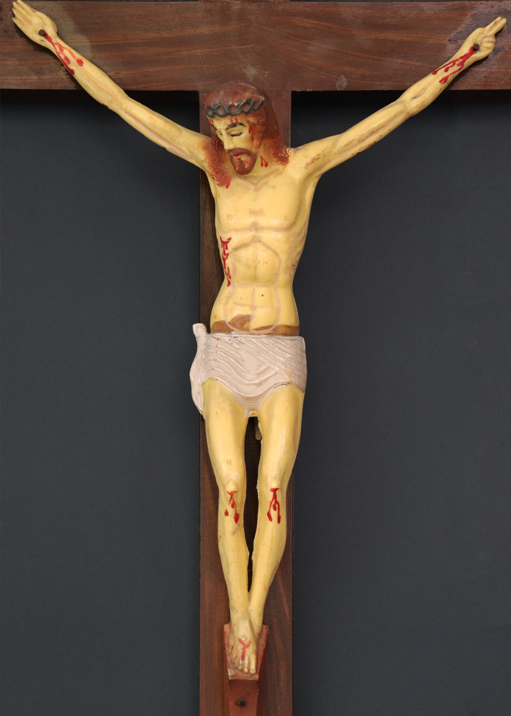 Vintage crucifix with Jesus probably made out of celluloid which is a form of early plastics. The moulded celluloid has been painted with details and the cross carries the traditional INRI plaque at the top. These lighter pieces were made to be a part of home altars, and should be from between the 1950s-1920s, India.