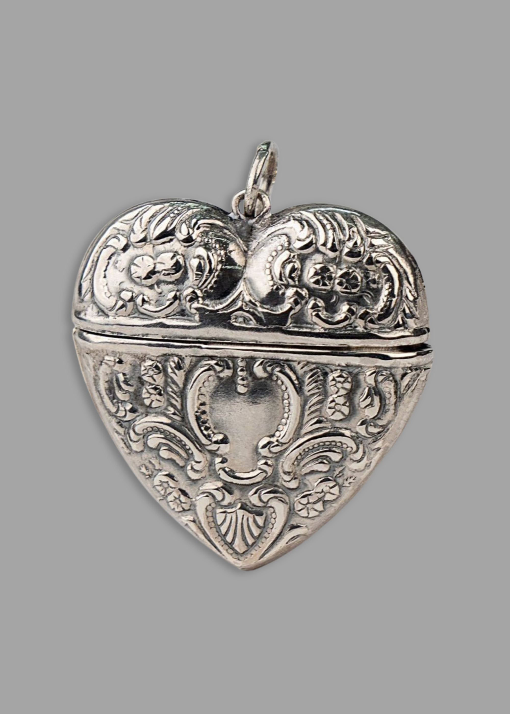 Victorian Engraved Heart Locket Pendant with floral motif - Openable and crafted in sterling silver. Store something precious inside this locket and take it with your wherever you go. Delivered globally.