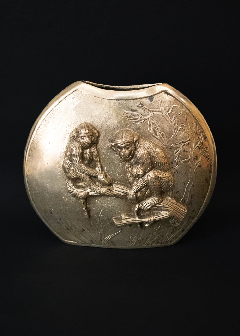 Vintage Meiji style vase with a family of Japanese macaques in high relief, surrounded by foliage. Macaques were considered sacred mediator between gods and humans, and represent good fortune, protection against evil, and wisdom. The same design is on both sides of the vase, the naturalistically rendered mother macaques caries a baby while another young macaques stands near them. The vase is cast in bronze or brass, and should bee from thee early 1900s Japan.
