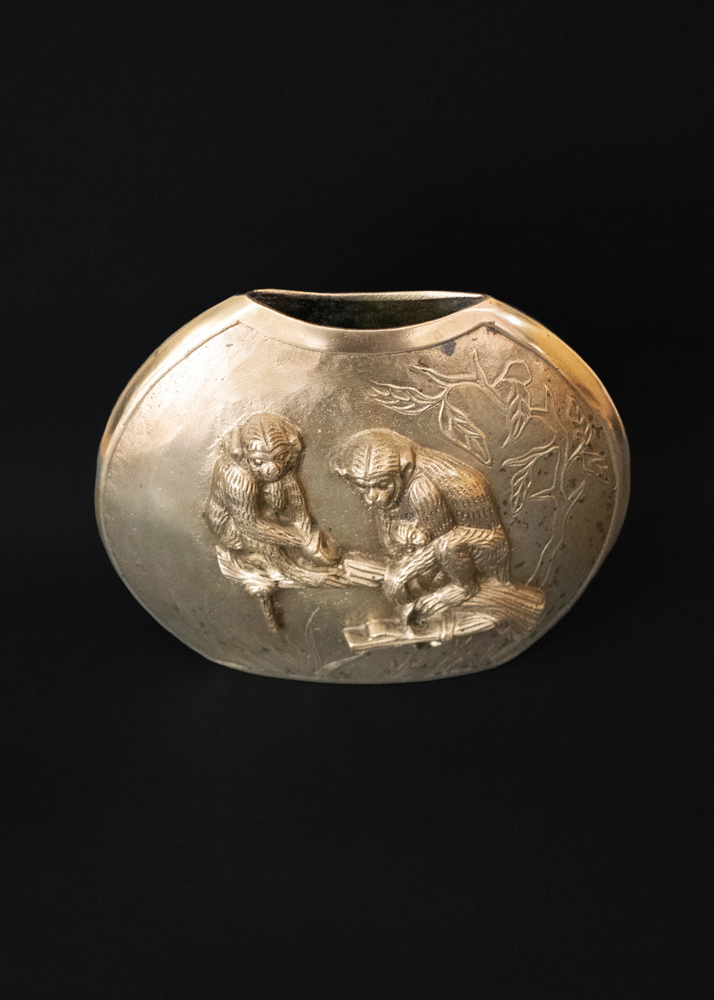 Vintage Meiji style vase with a family of Japanese macaques in high relief, surrounded by foliage. Macaques were considered sacred mediator between gods and humans, and represent good fortune, protection against evil, and wisdom. The same design is on both sides of the vase, the naturalistically rendered mother macaques caries a baby while another young macaques stands near them. The vase is cast in bronze or brass, and should bee from thee early 1900s Japan.