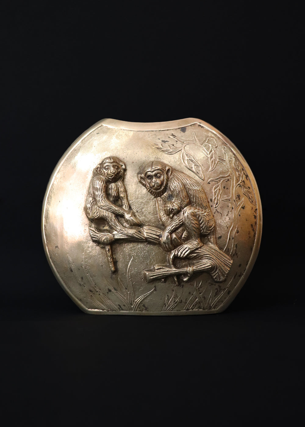 Vintage Meiji style vase with a family of Japanese macaques in high relief, surrounded by foliage. Macaques were considered sacred mediator between gods and humans, and represent good fortune, protection against evil, and wisdom. The same design is on both sides of the vase, the naturalistically rendered mother macaques caries a baby while another young macaques stands near them. The vase is cast in bronze or brass, and should bee from thee early 1900s Japan.