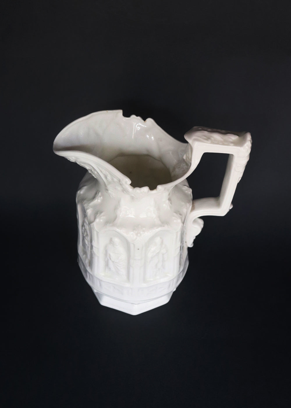 Vintage Apostle Jug featuring raised, molded figures of the apostles under Gothic-style architectural arches. This design was first made by Charles Meigh in 1842 in Staffordshire, and these pieces are displayed at the V&amp;A and the Metropolitan Museum. The arcaded "Gothic" decoration is a response by the pottery industry to the ideas of the influential architect and designer Augustus Charles Pugin (1762–1832). The design was so popular that several companies continued making them more than a 100 years aft