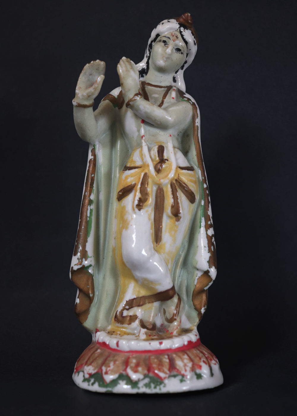 German made porcelain slip cast figure of Lord Krishna made for colonial India in the early 1900s. These figures were inspired by paintings by Raja Ravi Varma.
