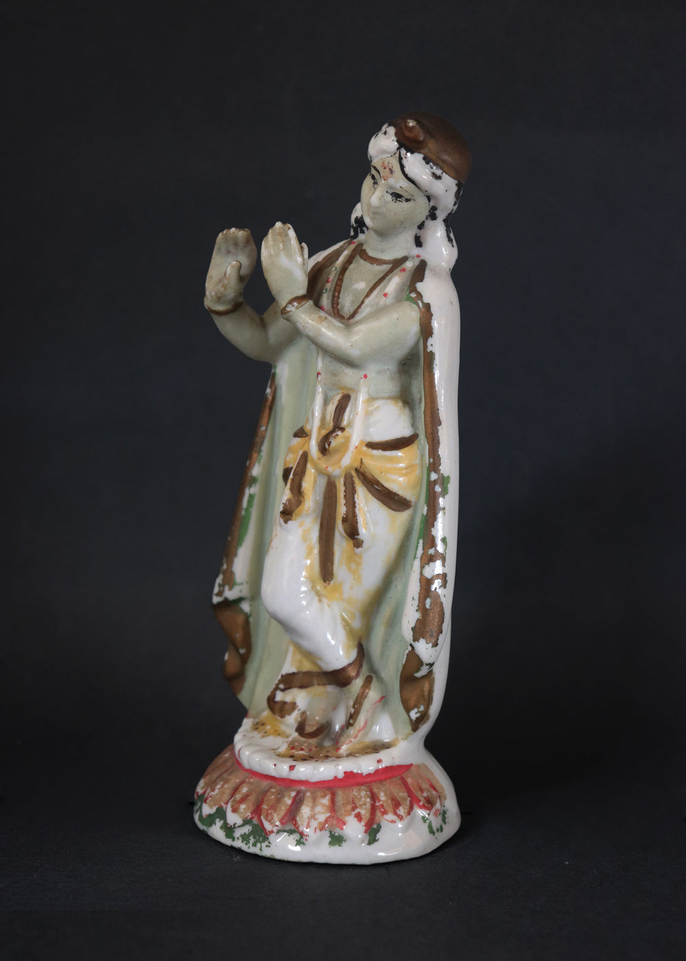 German made porcelain slip cast figure of Lord Krishna made for colonial India in the early 1900s. These figures were inspired by paintings by Raja Ravi Varma.