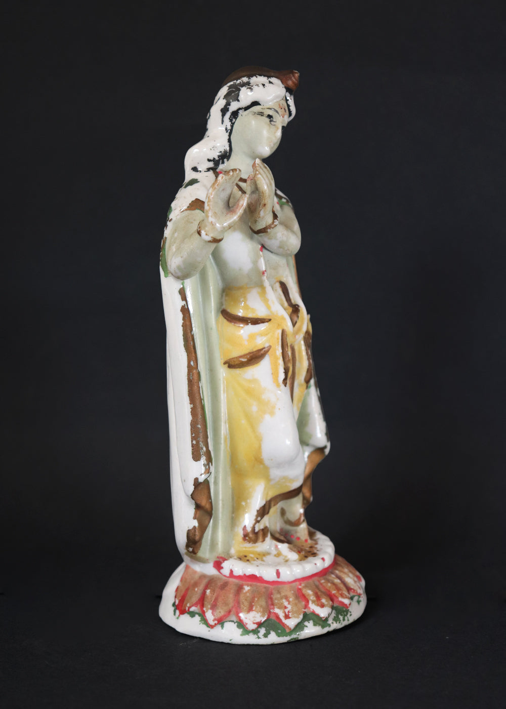 German made porcelain slip cast figure of Lord Krishna made for colonial India in the early 1900s. These figures were inspired by paintings by Raja Ravi Varma.