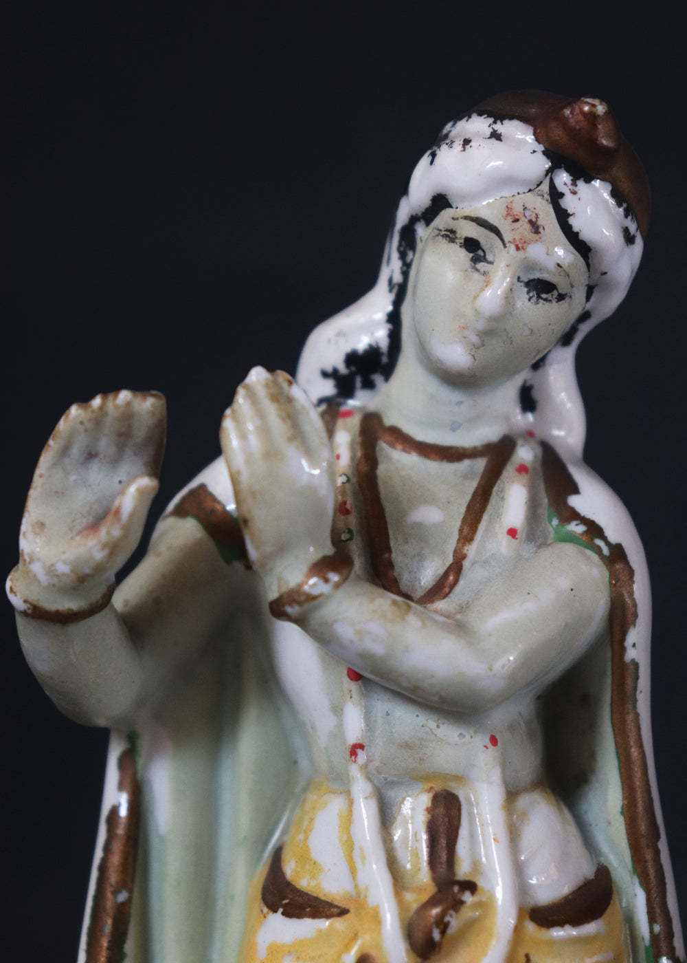 German made porcelain slip cast figure of Lord Krishna made for colonial India in the early 1900s. These figures were inspired by paintings by Raja Ravi Varma.