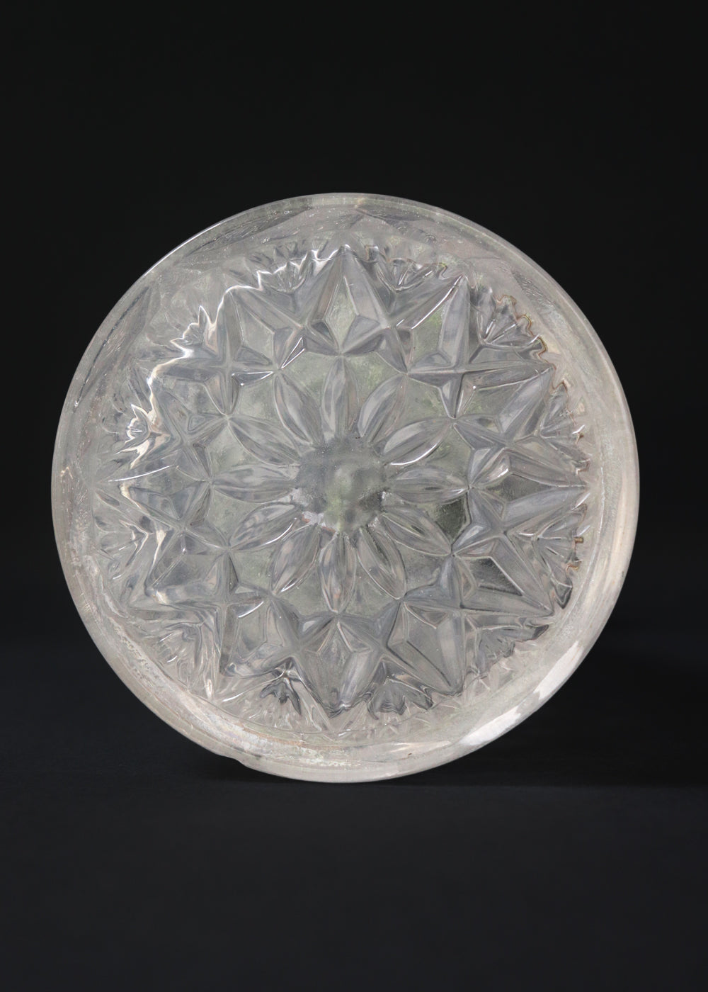 Vintage heavy cut glass decanter most likely meant for port wine. The bell shaped body is deeply facetted with patterns and has etched flowers around it. A diamond patterned ball shaped stopper sits atop the narrow neck. The crystal is somewhat cloudy but otherwise the decanter is in perfect condition. Should be from the mid 1900s, and most likely made in America.