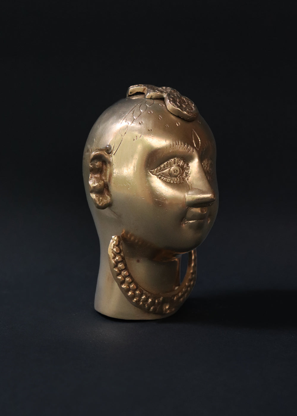 Vintage Brass Gauri head, the divine embodiment of Shakti, the Mother Goddess, the benevolent form of Parvati. She is highly bejewelled with a neckpiece, head and ear ornaments. The nose has a provision to adorn it with a nose ring. The piece has ben recently polished, and is in great condition From the mid 1900s India.