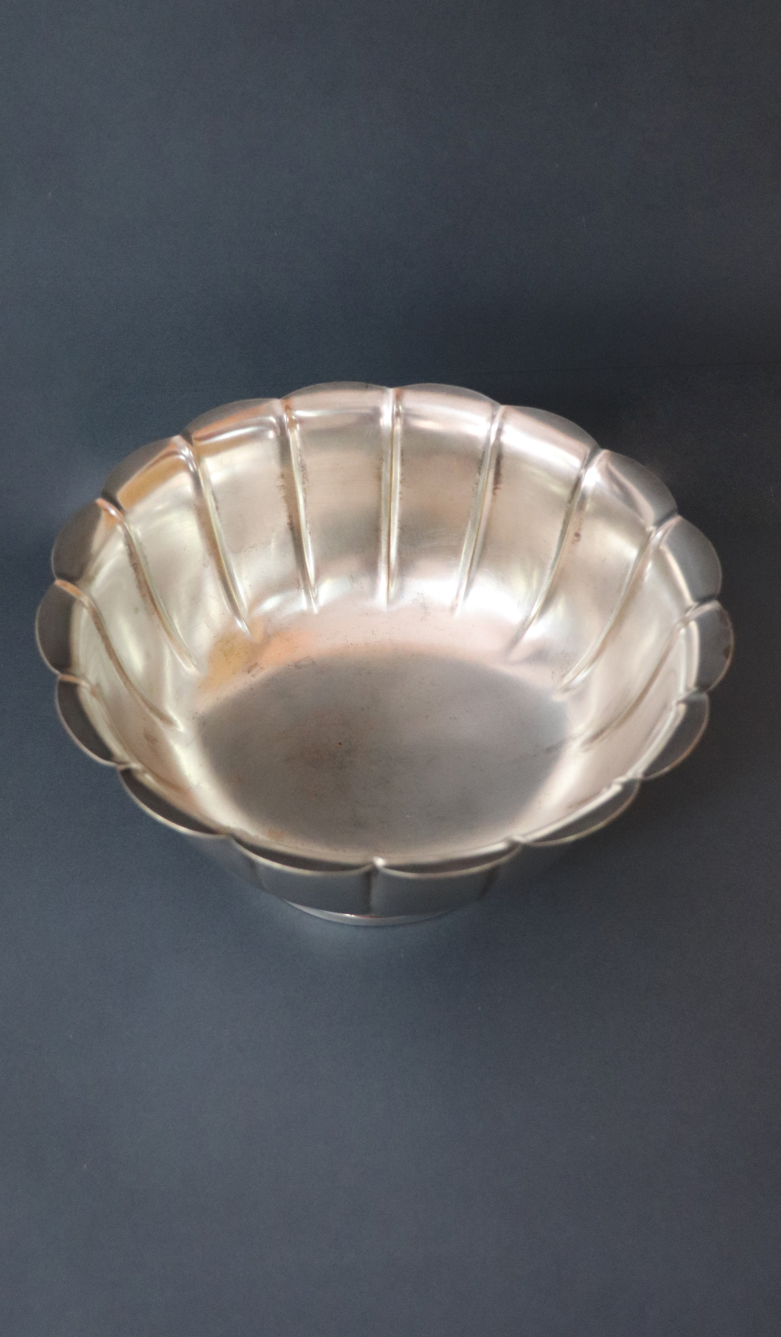 Vintage silver plated Rose Bowl with a classic lobed body and a scalloped undulating rim. The panels sweep upward to form an elegant petaled shape and it is raised on a stepped round pedestal base. It has the markings Sheffield England and a brand name that’s hard to read on the base. It would make a gorgeous centrepiece on dining or console table. Should be from the mid 1900s, England.