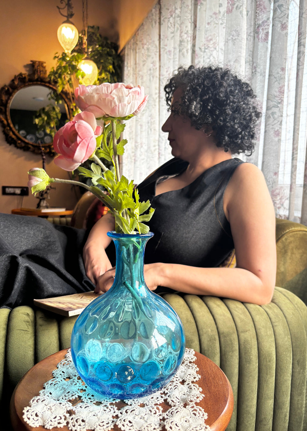 Vintage turquoise blue dimpled glass vase with a onion shaped body. It has a narrow elongated neck which widens out slightly to a rounded rim. The coin, dot or thumbprint pattern on its body is typical of the early to mid 1900s. Can also be used as a decanter.