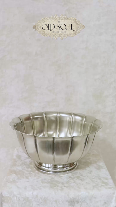 Vintage silver plated Rose Bowl with a classic lobed body and a scalloped undulating rim. The panels sweep upward to form an elegant petaled shape and it is raised on a stepped round pedestal base. It has the markings Sheffield England and a brand name that’s hard to read on the base. It would make a gorgeous centrepiece on dining or console table. Should be from the mid 1900s, England.