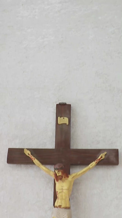 Vintage crucifix with Jesus probably made out of celluloid which is a form of early plastics. The moulded celluloid has been painted with details and the cross carries the traditional INRI plaque at the top. These lighter pieces were made to be a part of home altars, and should be from between the 1950s-1920s, India.