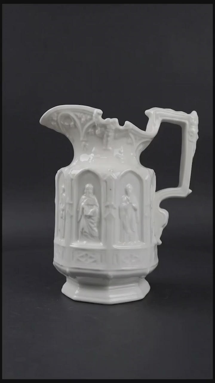 Vintage Apostle Jug featuring raised, molded figures of the apostles under Gothic-style architectural arches. This design was first made by Charles Meigh in 1842 in Staffordshire, and these pieces are displayed at the V&amp;A and the Metropolitan Museum. The arcaded "Gothic" decoration is a response by the pottery industry to the ideas of the influential architect and designer Augustus Charles Pugin (1762–1832). The design was so popular that several companies continued making them more than a 100 years aft