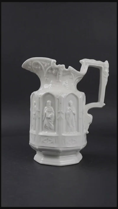 Vintage Apostle Jug featuring raised, molded figures of the apostles under Gothic-style architectural arches. This design was first made by Charles Meigh in 1842 in Staffordshire, and these pieces are displayed at the V&A and the Metropolitan Museum. The arcaded "Gothic" decoration is a response by the pottery industry to the ideas of the influential architect and designer Augustus Charles Pugin (1762–1832). The design was so popular that several companies continued making them more than a 100 years aft