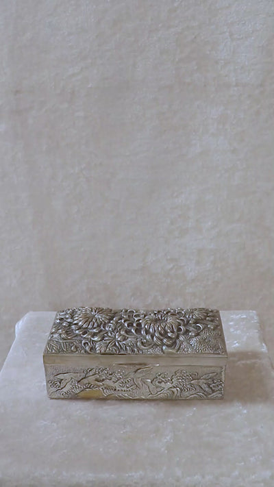 Meiji period Japanese box with very beautifully detailed chrysanthemums “kiku” in high relief and almost life-like petals. In Japan, the chrysanthemum is very cherished as a symbol of the imperial house, and the term “chrysanthemum throne” refers both to the actual throne as well as the emperor himself. Every year the 'Festival of Happiness' is celebrated in honour of the chrysanthemum. The side panels of the box depict birds in stormy seas with waves in the style of The Great Wave by Hokusai, all in relief