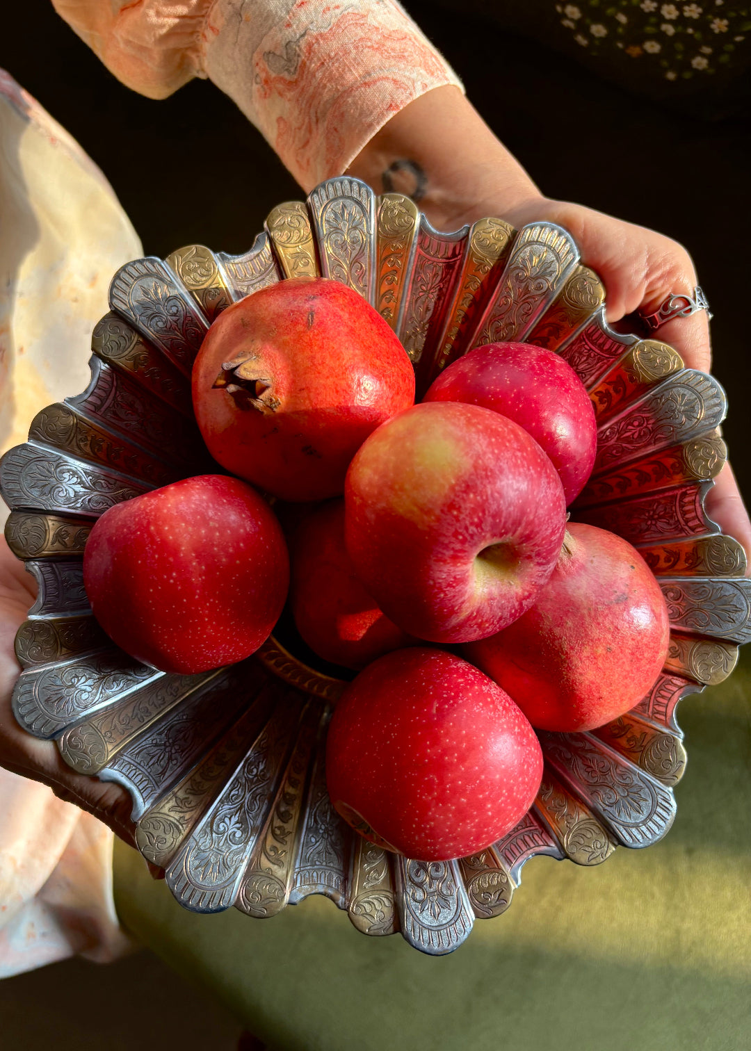 Gorgeous vintage Persian style two-toned fruit bowl in brass. The flower shaped bowl has a scalloped edge and has been constructed with 40 lobed panels at different heights, with alternating gold and silver plating. It is intricately hand-etched throughout. It stands raised on a stepped round base. It would make a beautiful centrepiece for any table. Early to mid 1900s.