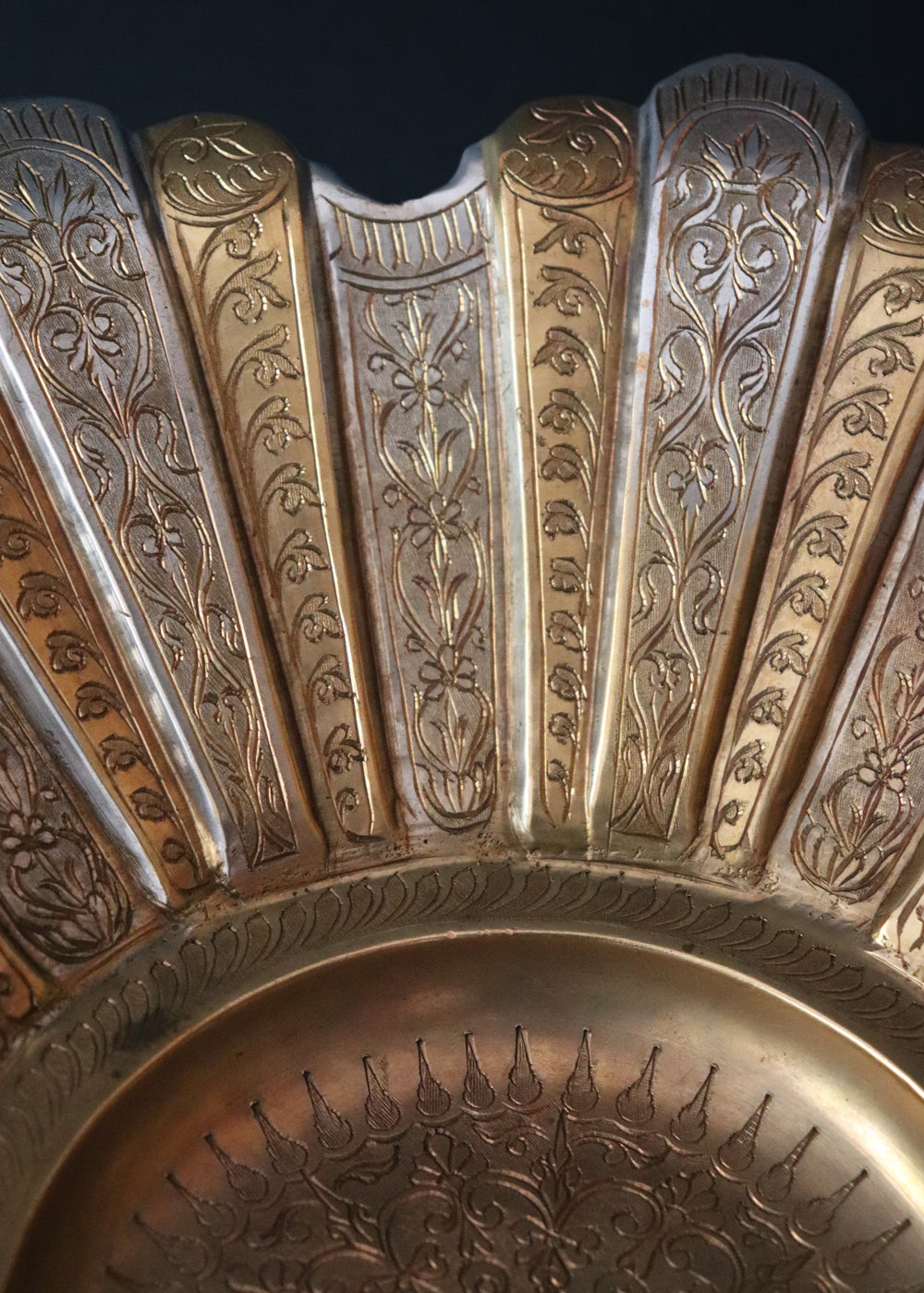 Gorgeous vintage Persian style two-toned fruit bowl in brass. The flower shaped bowl has a scalloped edge and has been constructed with 40 lobed panels at different heights, with alternating gold and silver plating. It is intricately hand-etched throughout. It stands raised on a stepped round base. It would make a beautiful centrepiece for any table. Early to mid 1900s.