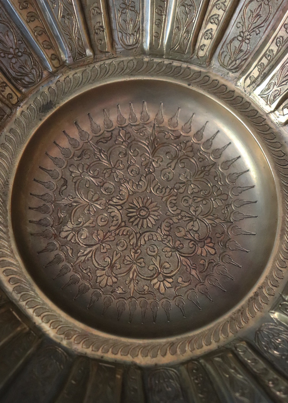 Gorgeous vintage Persian style two-toned fruit bowl in brass. The flower shaped bowl has a scalloped edge and has been constructed with 40 lobed panels at different heights, with alternating gold and silver plating. It is intricately hand-etched throughout. It stands raised on a stepped round base. It would make a beautiful centrepiece for any table. Early to mid 1900s.