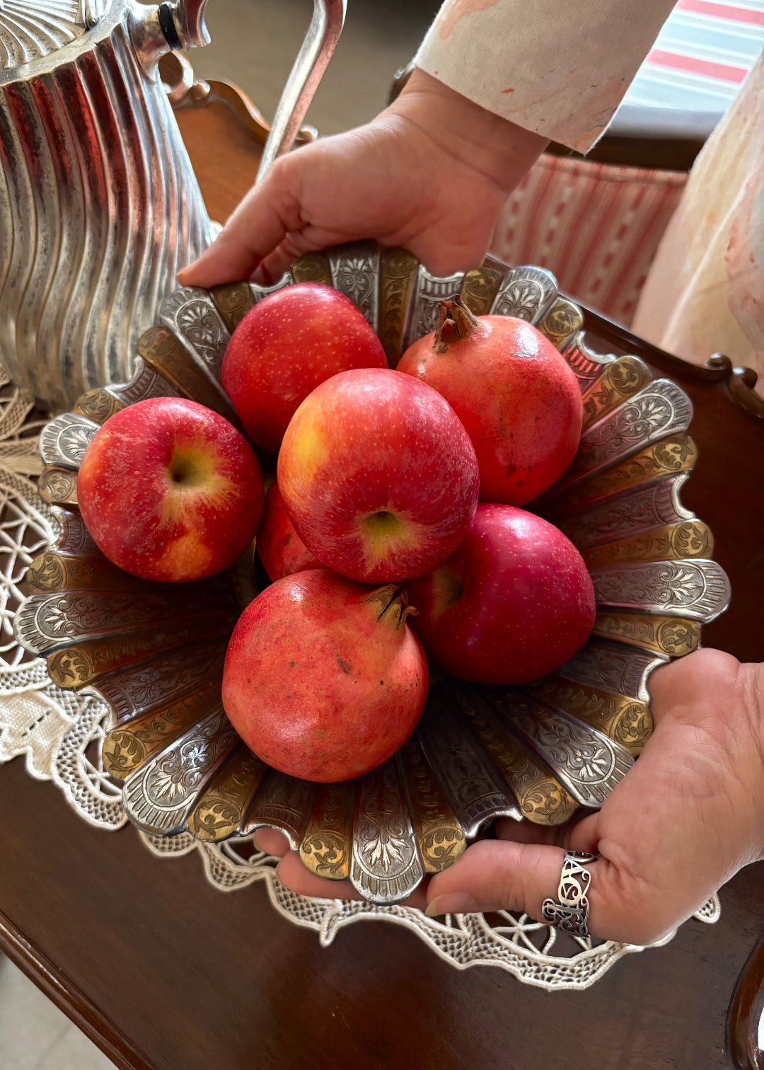 Gorgeous vintage Persian style two-toned fruit bowl in brass. The flower shaped bowl has a scalloped edge and has been constructed with 40 lobed panels at different heights, with alternating gold and silver plating. It is intricately hand-etched throughout. It stands raised on a stepped round base. It would make a beautiful centrepiece for any table. Early to mid 1900s.