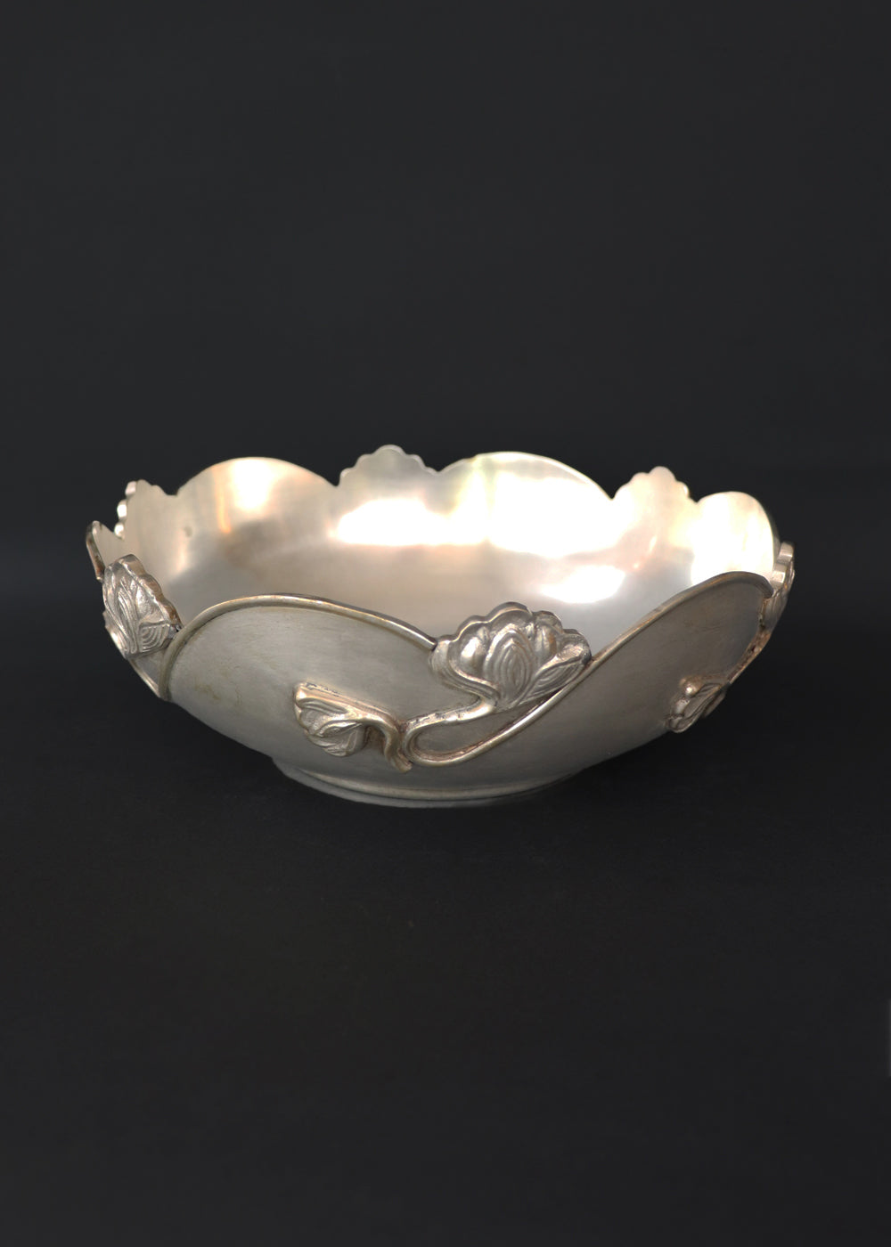 Beautiful silver-plated Art Nouveau bowl decorated with water lilies. The curvaceous floral and vine are cast and applied on the scalloped rim and sides of the bow and are classic art nouveau. This is a perfect fruit bowl or center piece. Made in France, early 1900s.